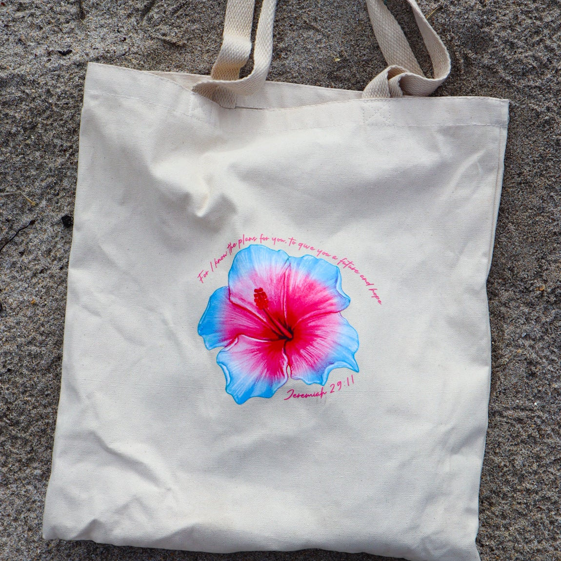 Tote bag with a colorful flower design on a textured surface